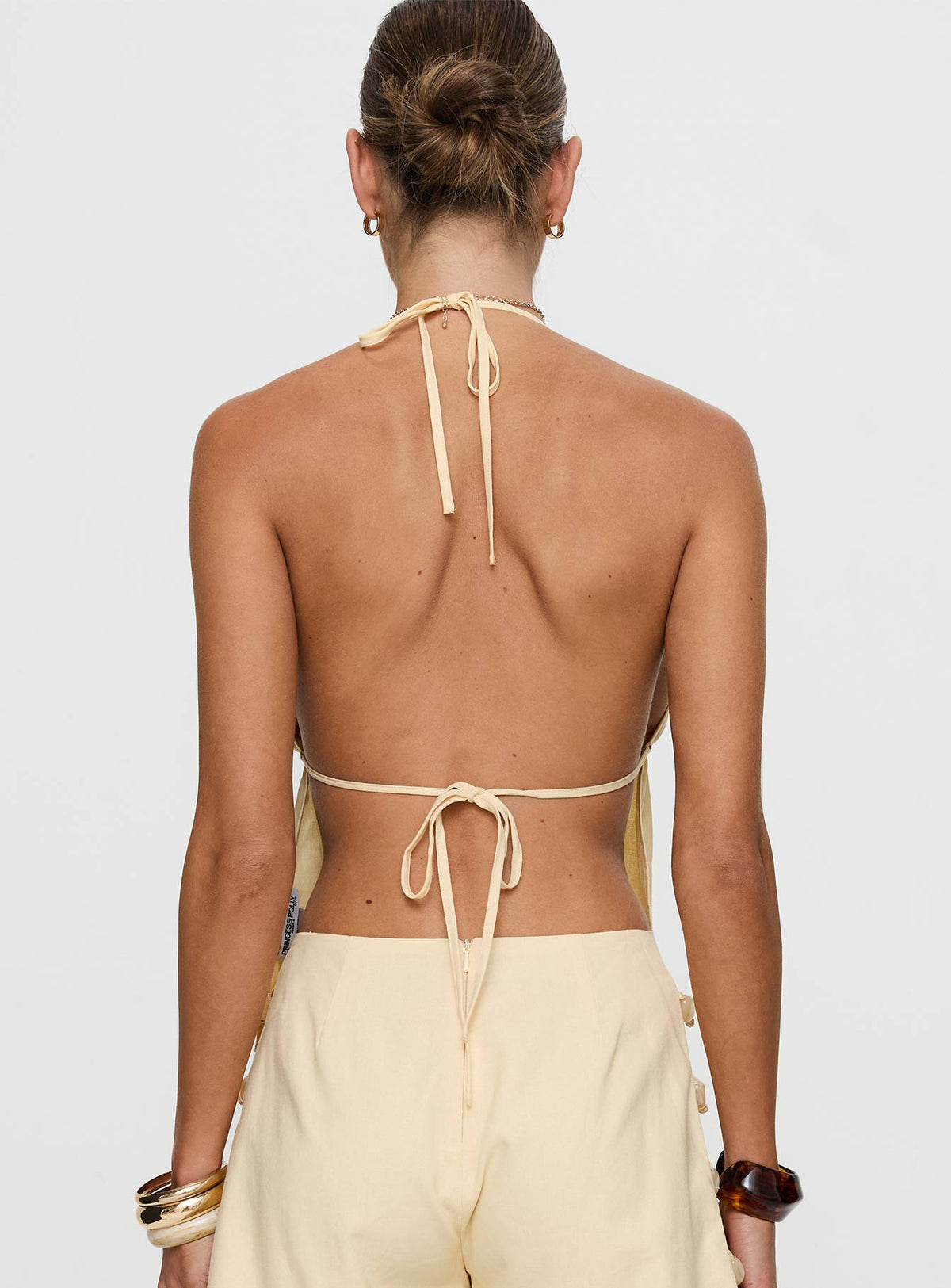 back view of model wearing Princess Polly Solid Gold Top Lemon Sleeveless Plunger 