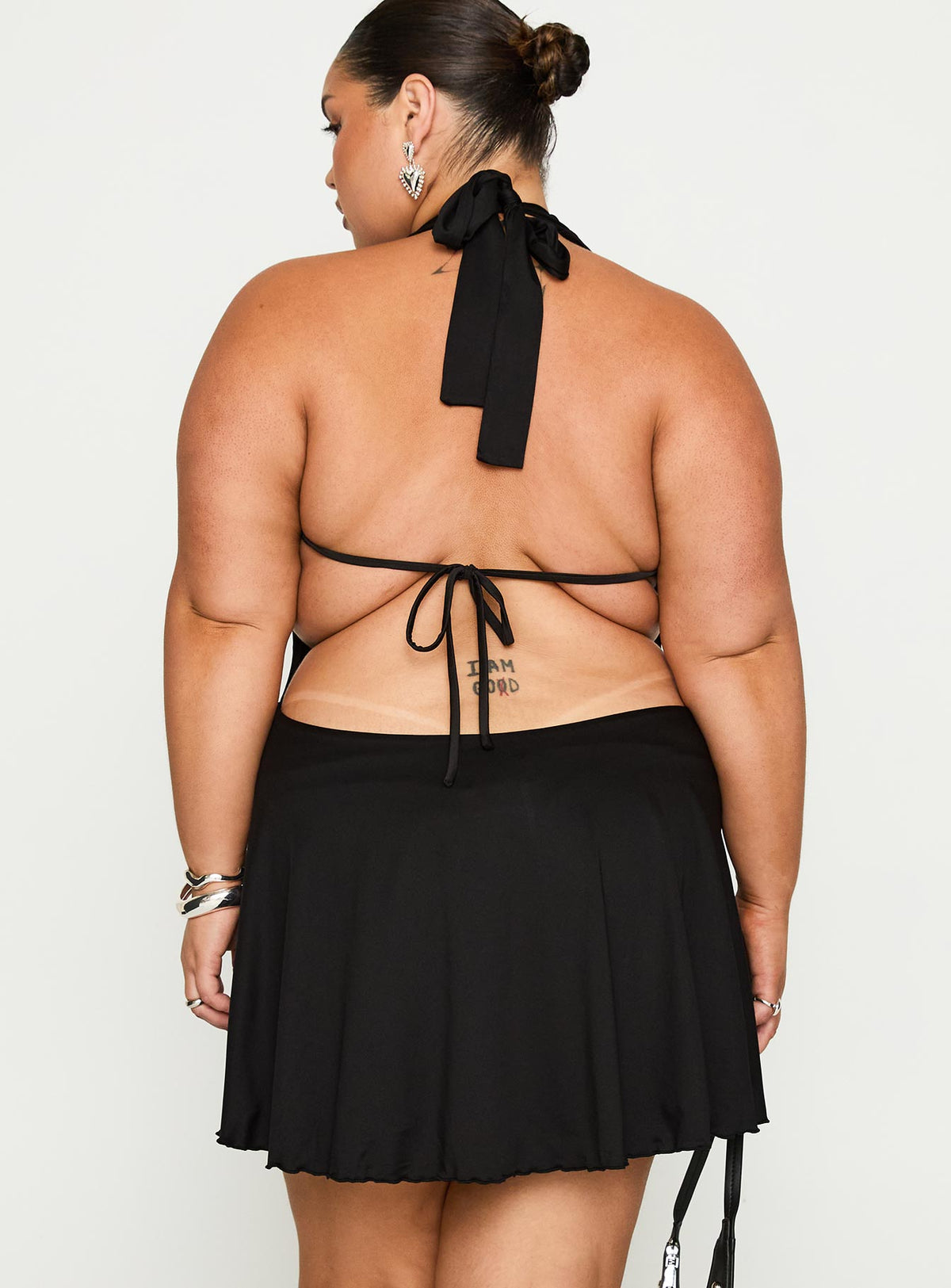 back view of model wearing Princess Polly Maeva Halter Mini Dress Black Curve Plunger 