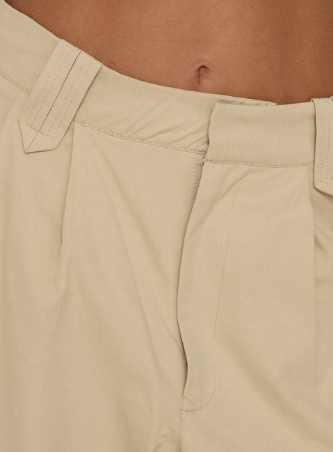 Designed with high-rise pleated detailing the Kendall Pant Sand womens-regular-pants in tan wide-leg fit product