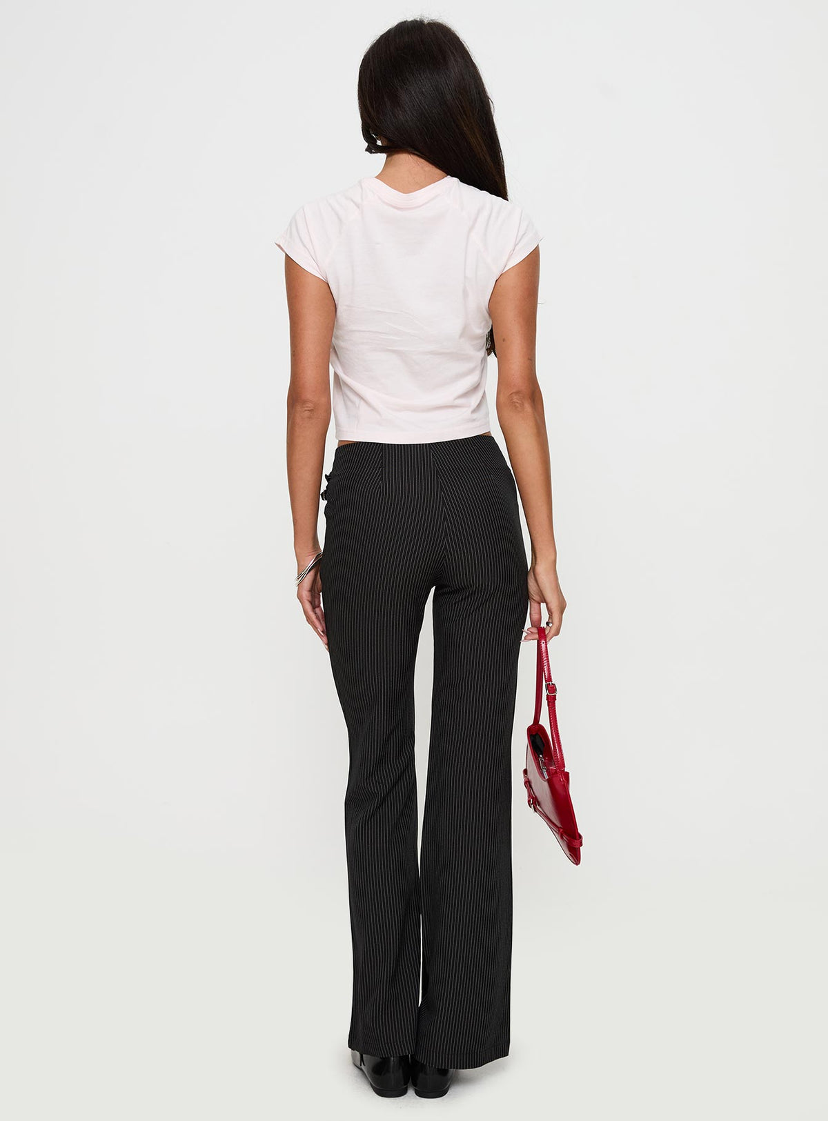 back view of model wearing Princess Polly Sympathiser Pinstripe Pants Black Low Rise Pants Pants 