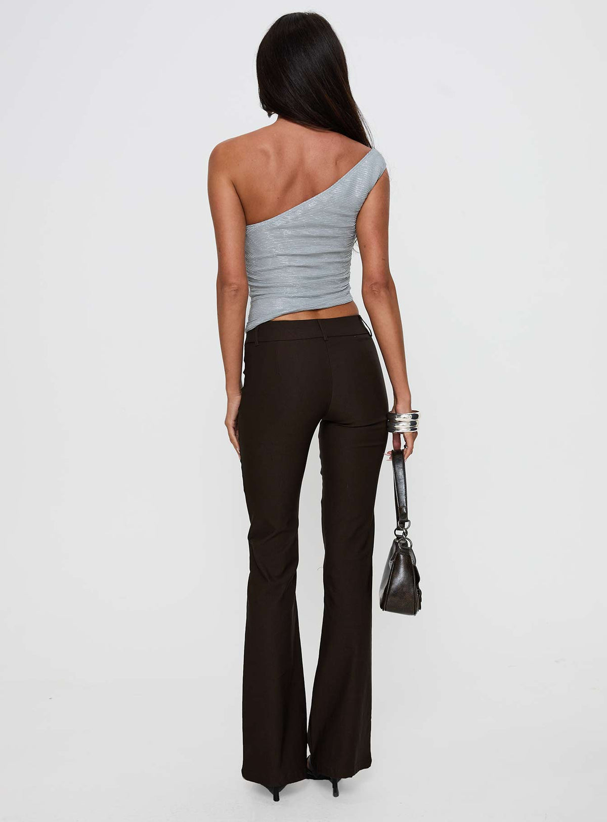 back view of model wearing Princess Polly Kinkirk Flared Pants Chocolate Petite Low Rise Pants Pants 