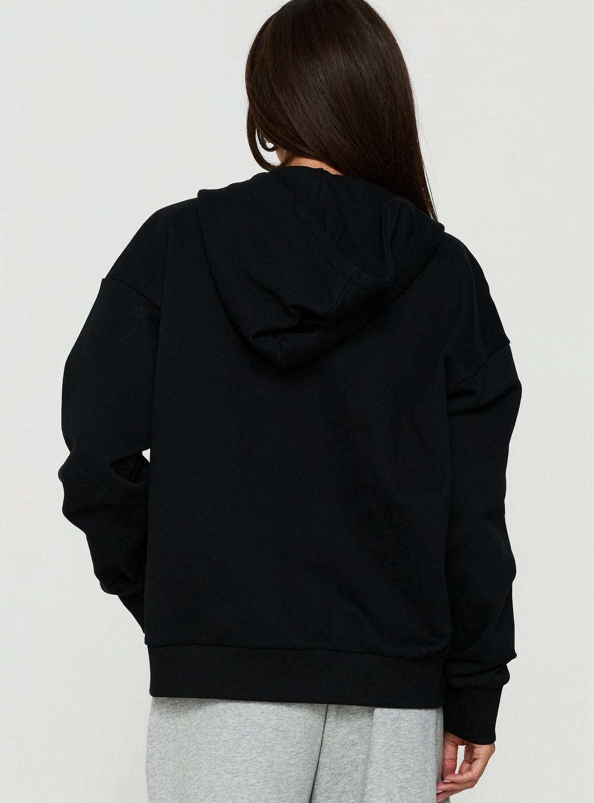 Shop the All Day Studded Oversized Hoodie Black womens-jumpers in short length back view of model wearing Princess Polly