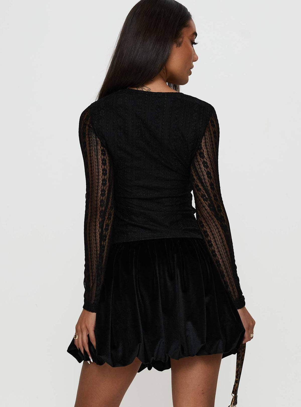 back view of model wearing Princess Polly Georgiana Bubble Hem Mini Skirt Black Mini Skirts Skirts 