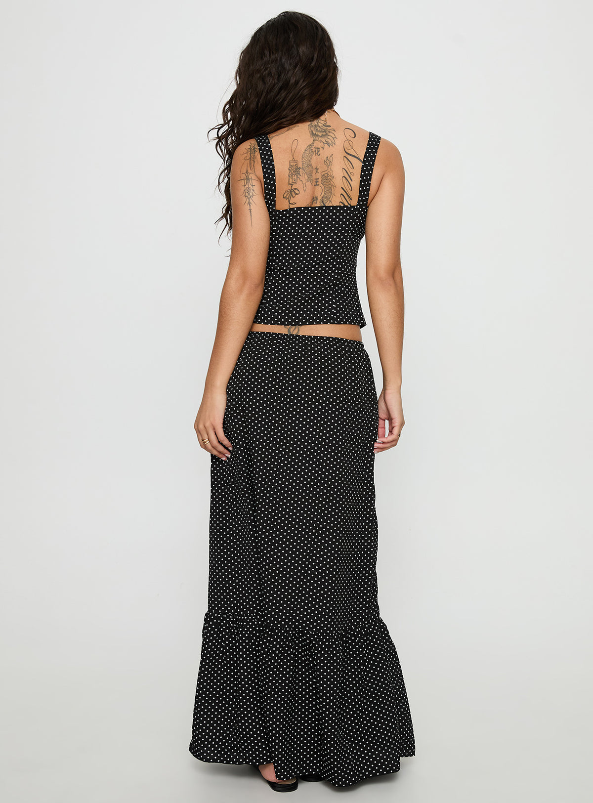back view of model wearing Princess Polly Modern Girl Maxi Skirt Black / Polka Dot Skirts 