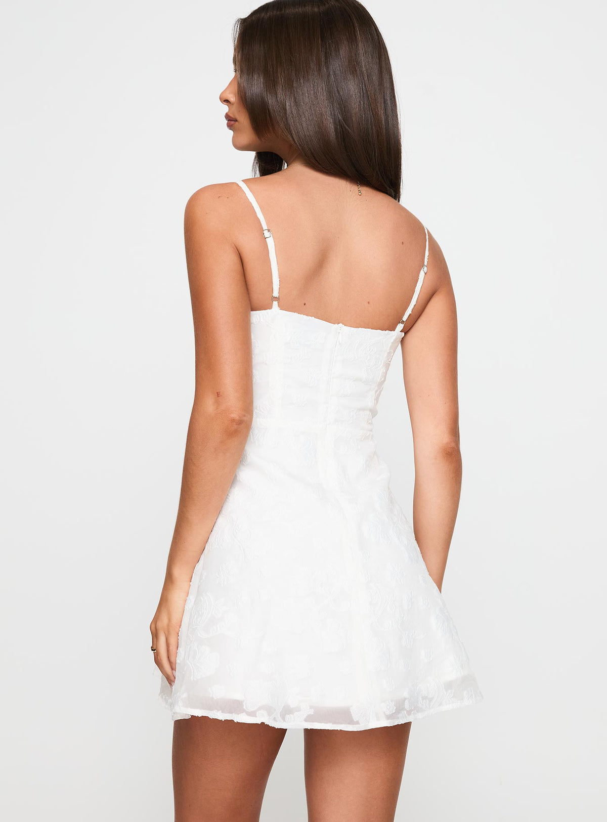 back view of model wearing Princess Polly New Chapters Broderie Mini Dress White Sweetheart Neckline 