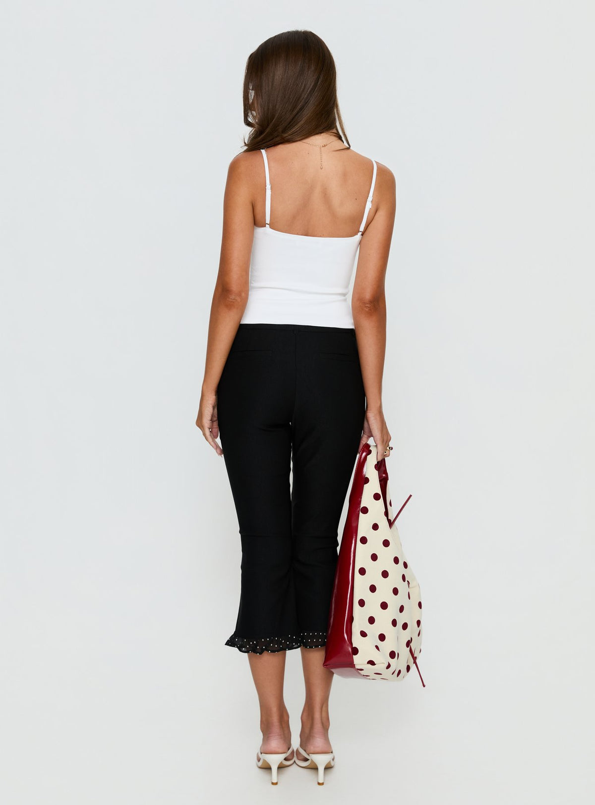 back view of model wearing Princess Polly Darsie Frill Capri Black Polka Dot High Rise Pants Pants 