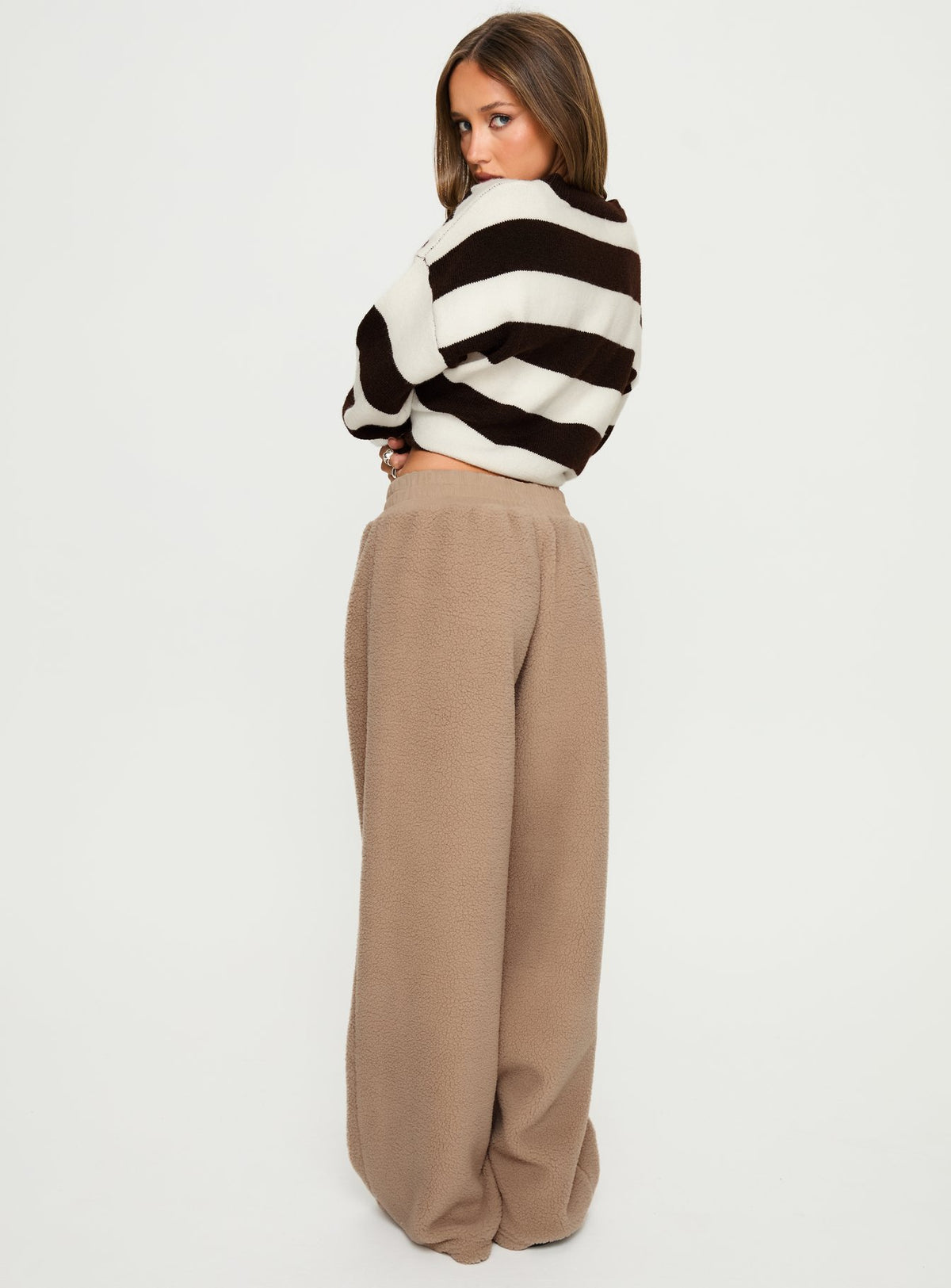 side view of model wearing Princess Polly Siberia Fleece Track Pant Light Brown High Rise Pants Pants 