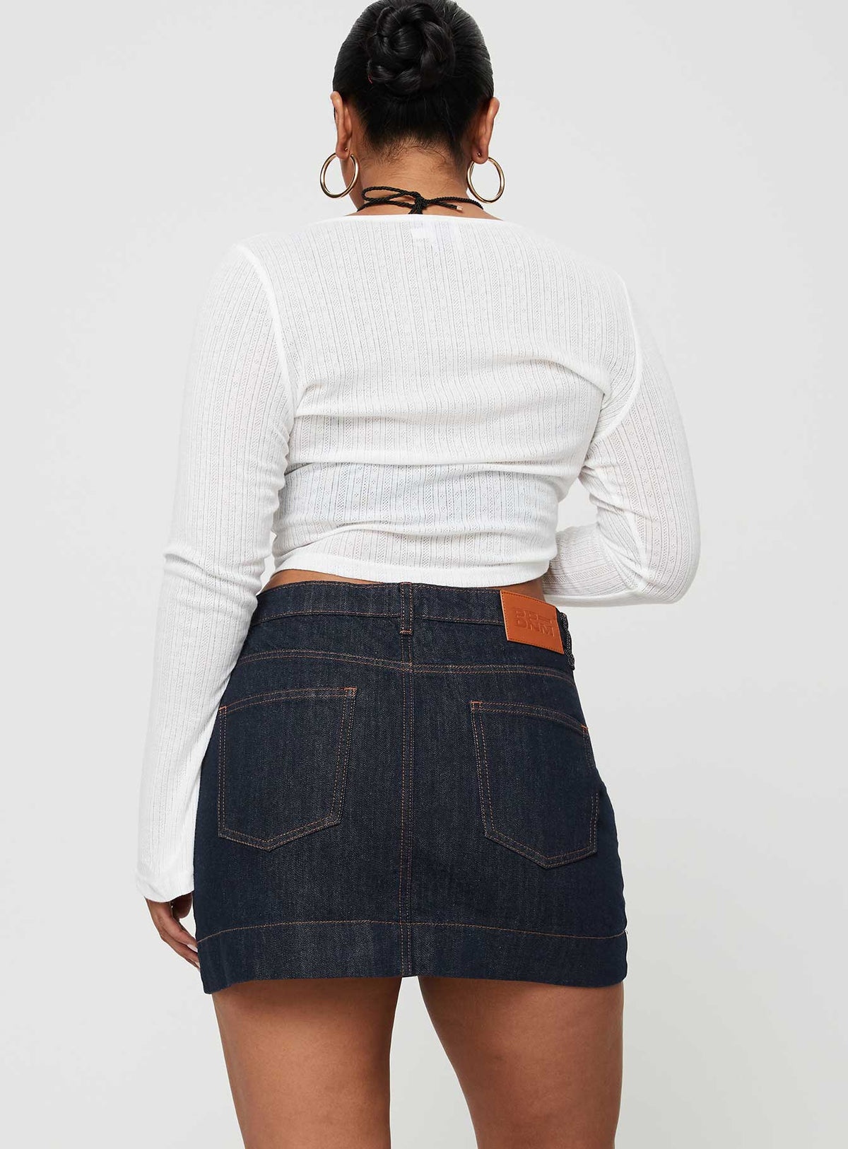 back view of model wearing Princess Polly Hughes Mini Skirt Dark Wash Denim Petite Mini Skirts Skirts 