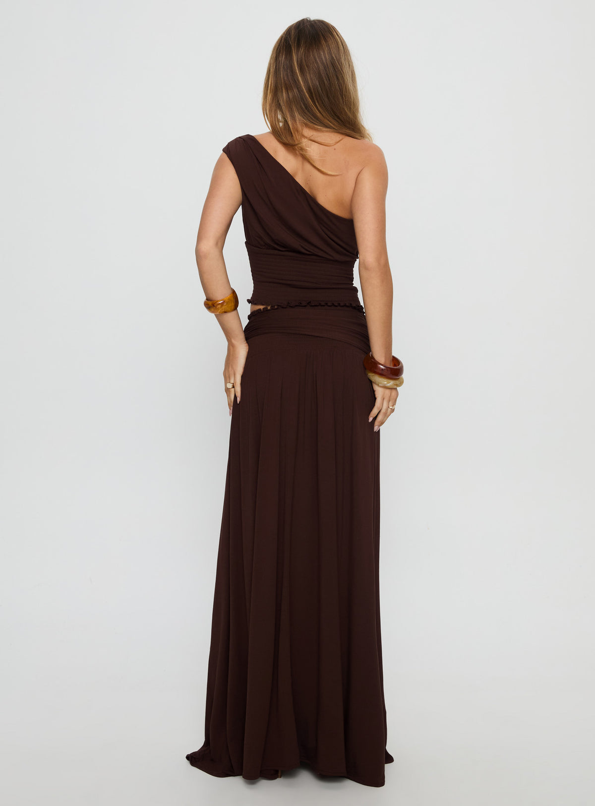 back view of model wearing Princess Polly Full Orbit Shirred Maxi Skirt Chocolate Brown Maxi Skirts Skirts 