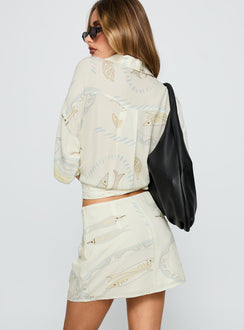 back view of model wearing Princess Polly Caraliia Mini Skirt Cream Mini Skirts Skirts 