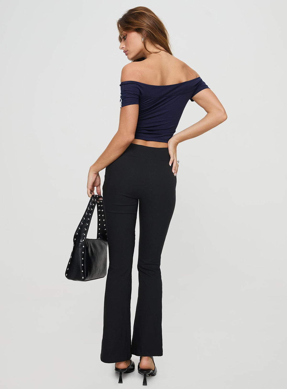 back view of model wearing Princess Polly Everyday Flared Pants Black High Waisted Pants 