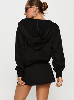 back view of model wearing Princess Polly Down Low Fleece Skort Black Low Rise Shorts 