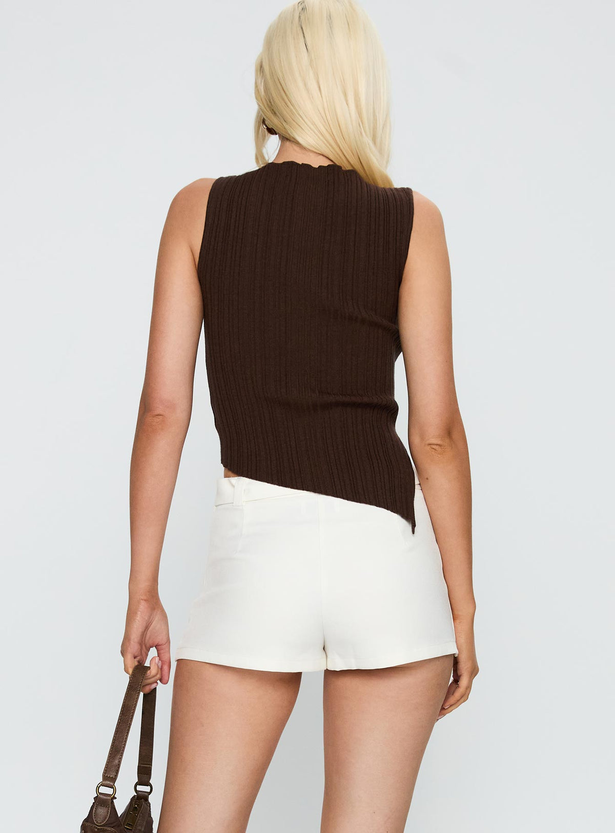 back view of model wearing Princess Polly Volley Mini Skort White Low Rise Shorts 