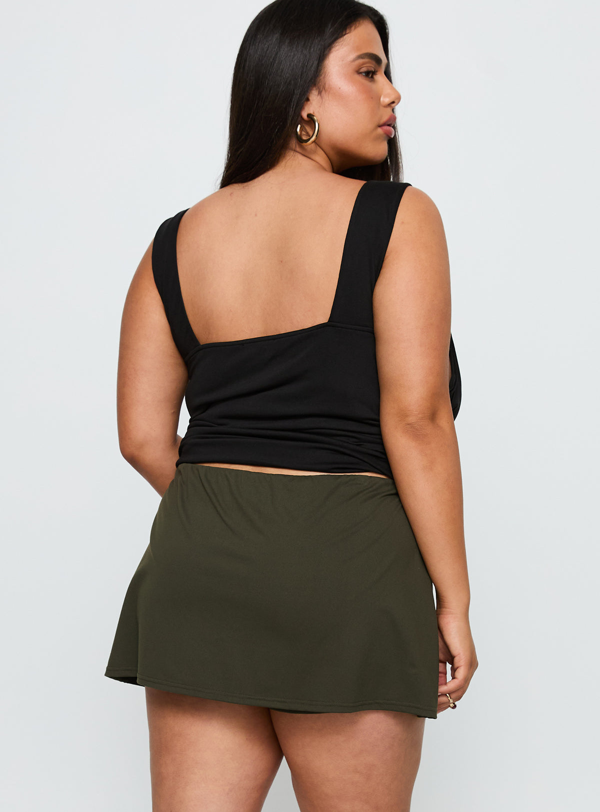 back view of model wearing Princess Polly For The Thrill Skort Green Curve High Waisted Shorts 