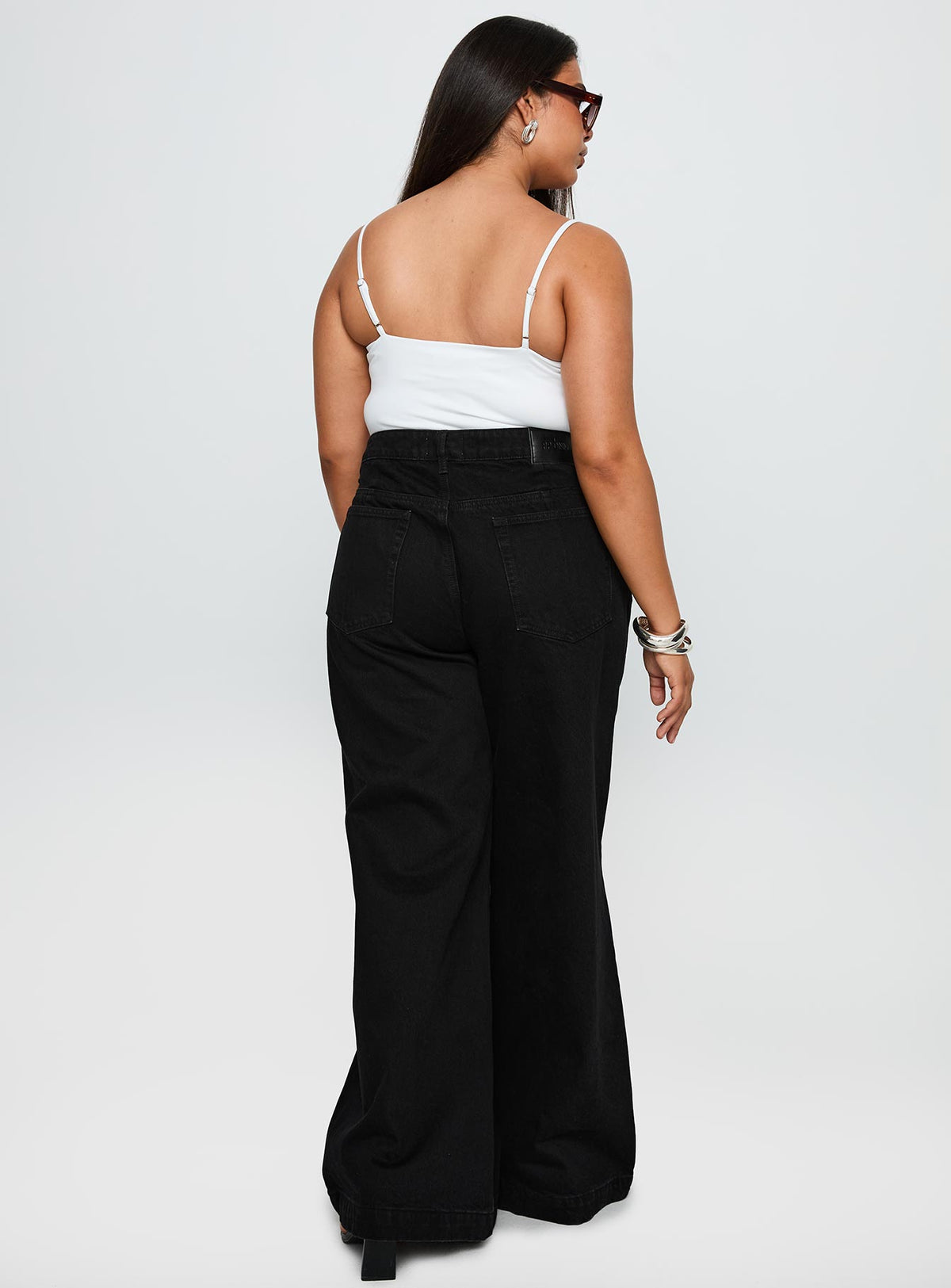 back view of model wearing Princess Polly Goldie High Rise Wide Leg Jeans True Black Curve High Rise Jeans Jeans 