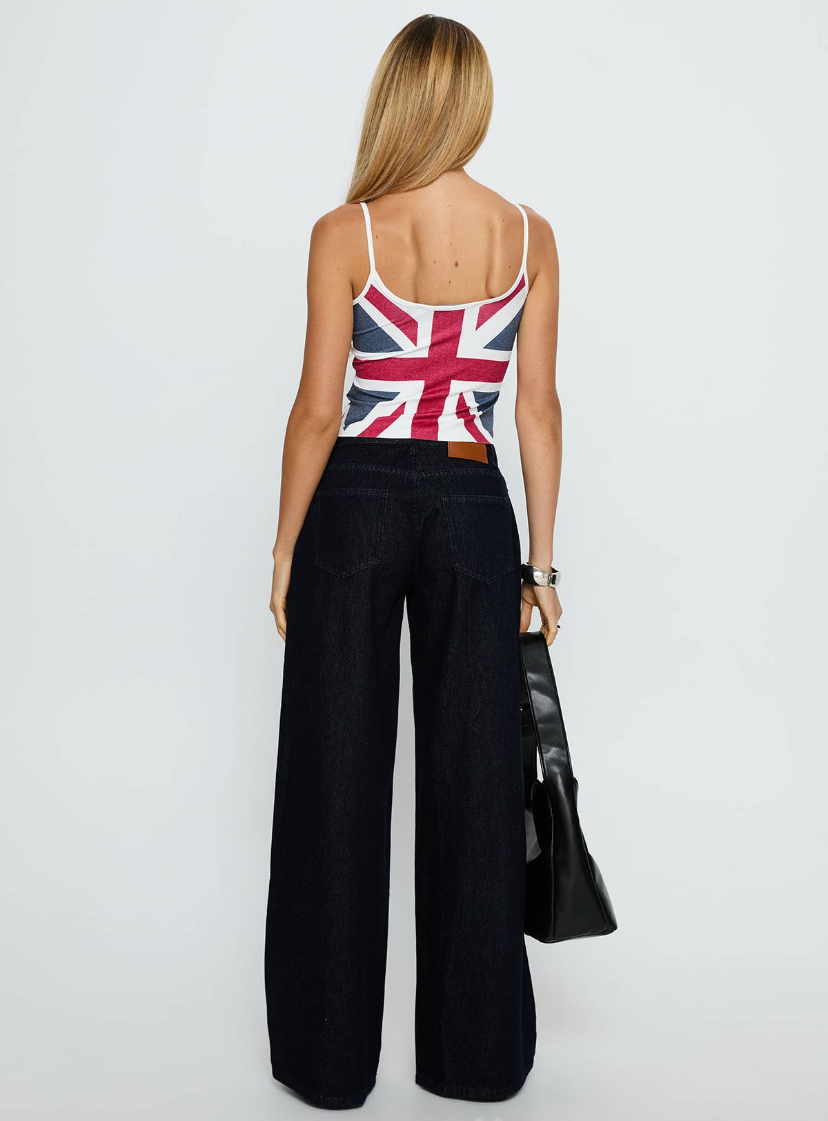 back view of model wearing Princess Polly Ramos Low Rise Wide Leg Jeans Raw Indigo Blue Low Rise Jeans Jeans 