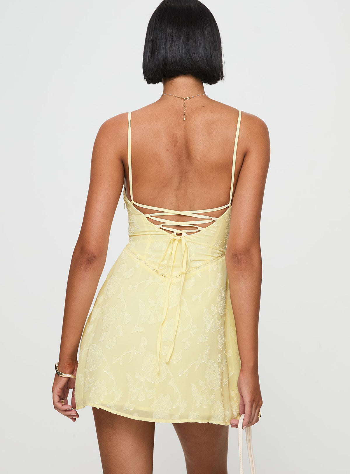 back view of model wearing Princess Polly South Of France Mini Dress Yellow Petite Square Neck 