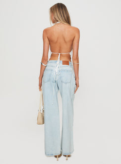 back view of model wearing Princess Polly Brayden Low Rise Relaxed Jeans Light Acid Wash Low Rise Jeans Jeans 