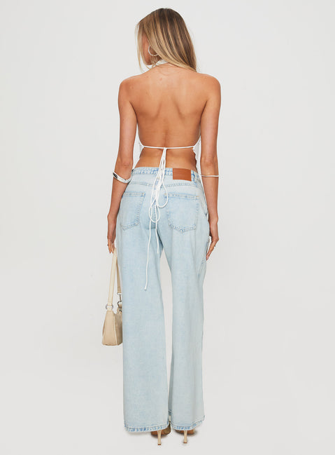 back view of model wearing Princess Polly Brayden Low Rise Relaxed Jeans Light Acid Wash Low Rise Jeans Jeans 