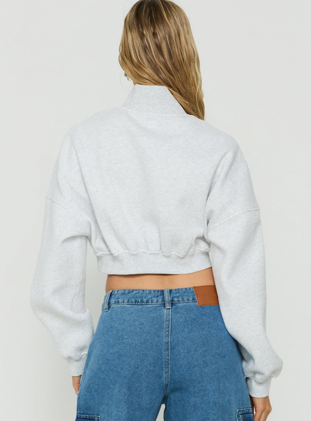 Styled in the Astridd 3/4 Zip Cropped Jumper Grey Marle womens jumper with short length back view of model wearing Princess Polly