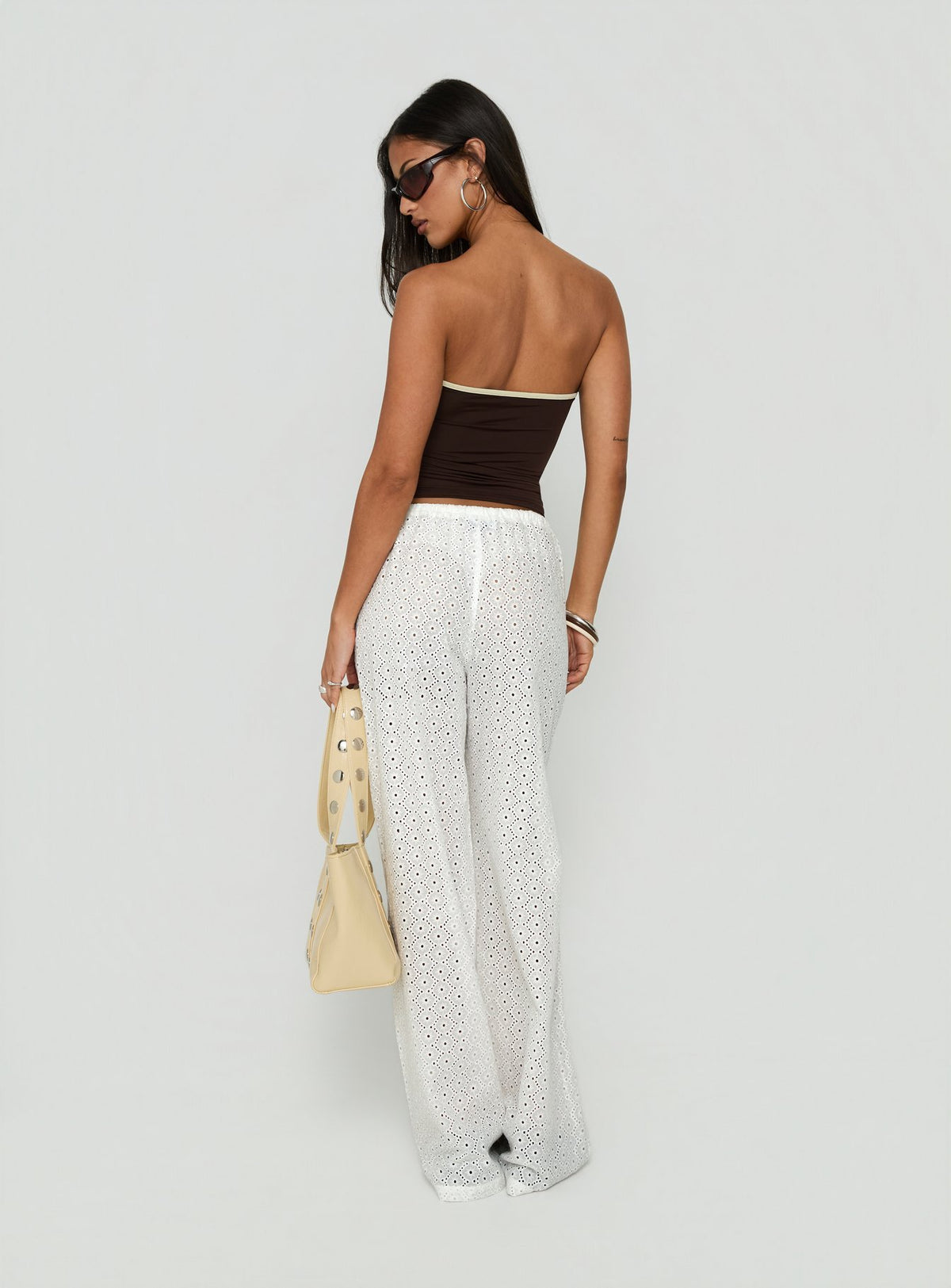 Presenting the Lindora Drawstring Wide Leg Pants White Broderie in womens-regular-pants with mid-rise waist back view of model wearing Princess Polly