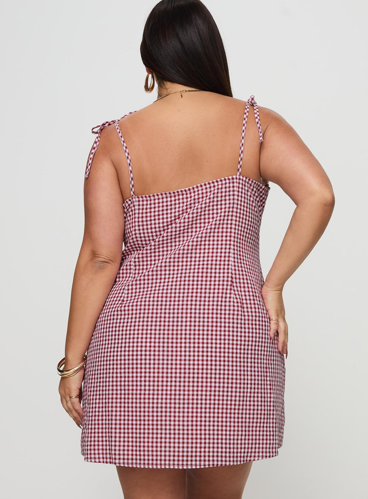 back view of model wearing Princess Polly Burkes Mini Dress Red Check Curve Square Neck 