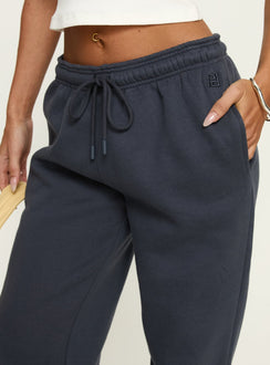 back view of model wearing Princess Polly Caspa Dream Fleece Oversized Ankle Cuff Jogger Navy High Rise Pants Pants 