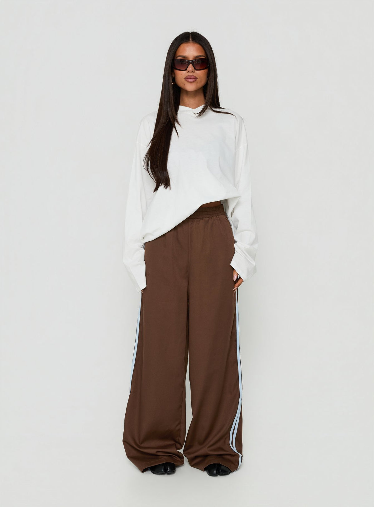 Explore the Fielder Track Pants Brown / Blue womens-regular-pants with high-rise on-body view of model wearing Princess Polly
