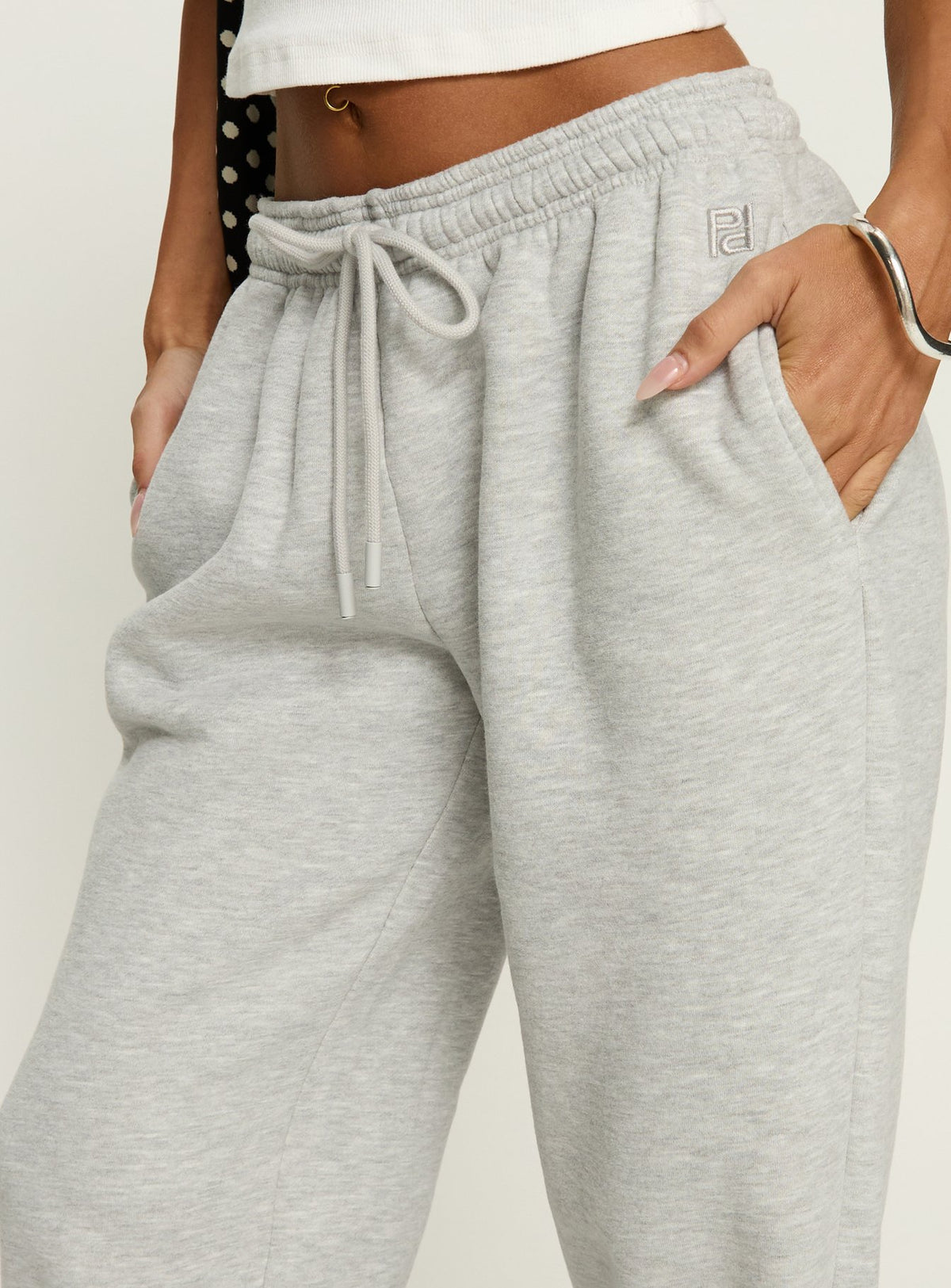 side view of model wearing Princess Polly Caspa Dream Fleece Oversized Ankle Cuff Jogger Grey Marle High Rise Pants Pants 