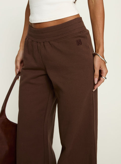 side view of model wearing Princess Polly Summits Flared Track Pants Chocolate High Rise Pants Pants 