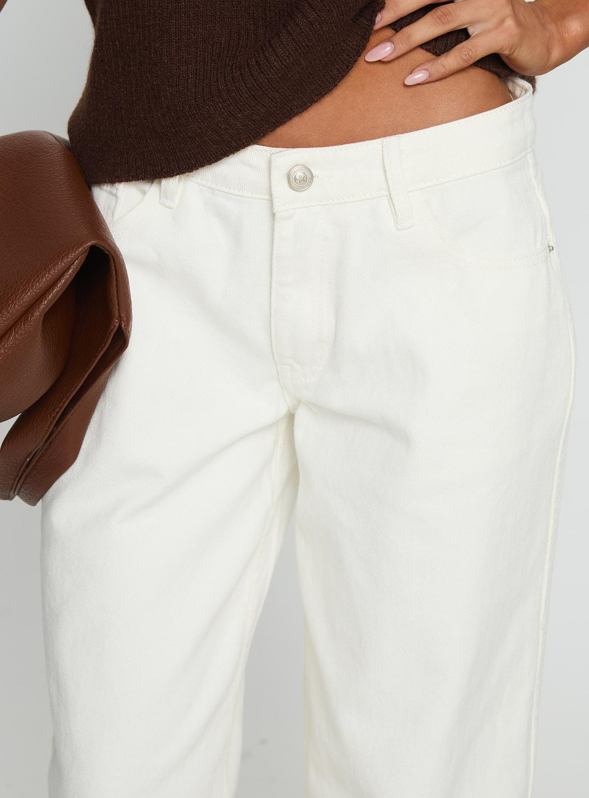 side view of model wearing Princess Polly Ramos Low Rise Wide Leg Jeans White Low Rise Jeans 