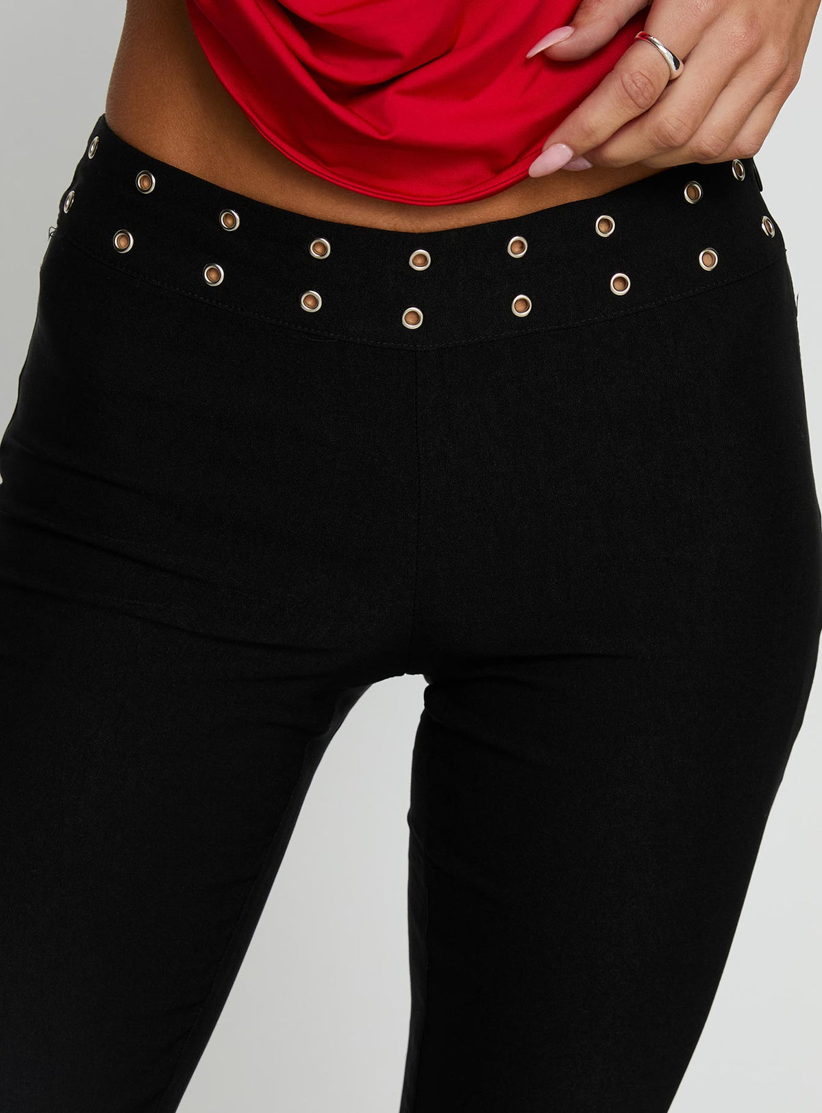 Showcasing the Yevina Eyelet Flare Pant Black Tall womens-regular-pants with high-rise detail view of model wearing Princess Polly
