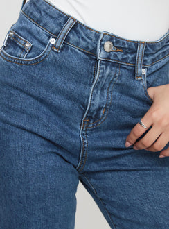 back view of model wearing Princess Polly Lucille High Rise Flared Jeans Mid Wash High Rise Jeans Jeans 