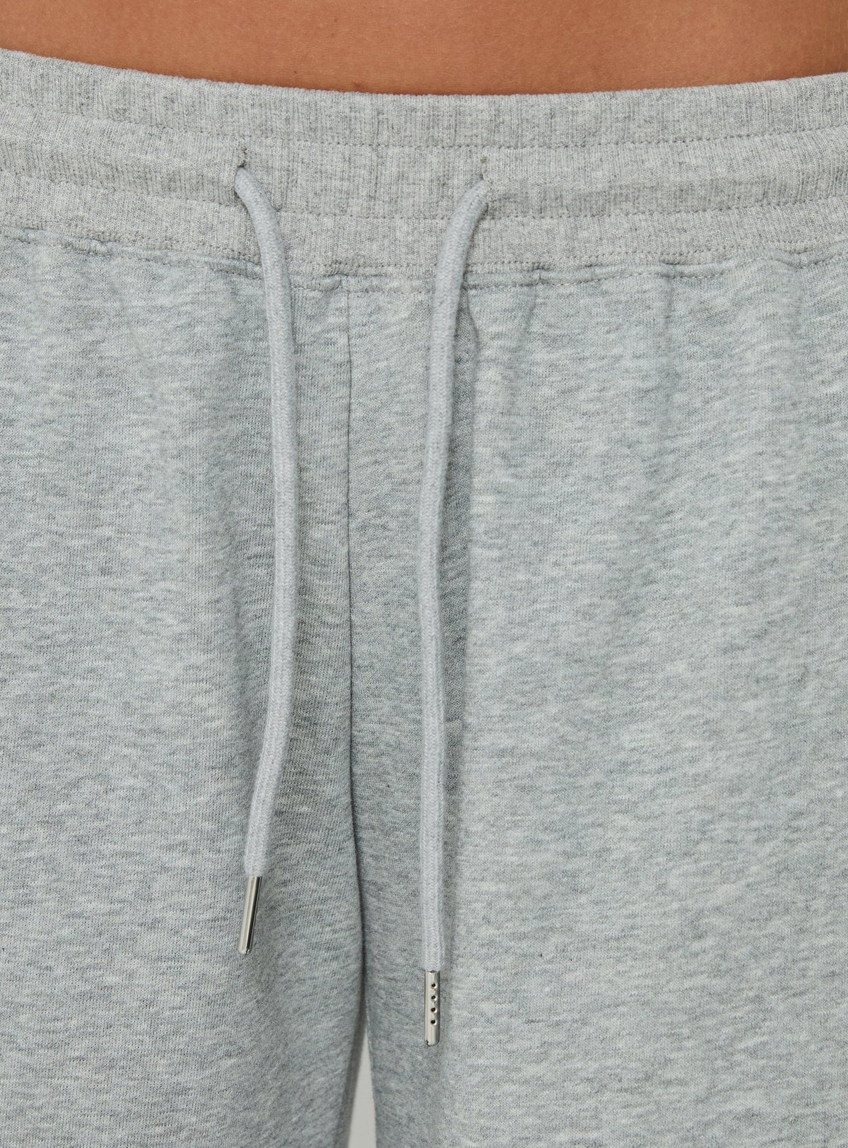Highlighting the drawstring detail of the Nikko Longline Fleece Shorts Grey Marle in womens regular pants with mid-rise Princess Polly