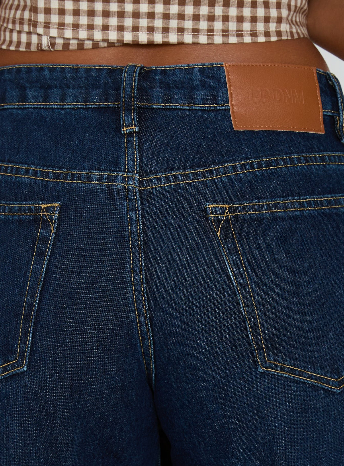 back view of model wearing Princess Polly Darla Low Rise Straight Leg Cuff Jean Dark Blue Wash Low Rise Jeans Jeans 