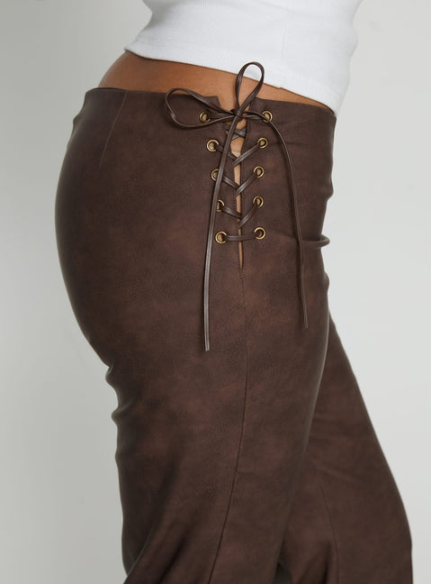 side view of model wearing Princess Polly Trickrider Tie Side Faux Leather Pants Chocolate Mid Rise Pants Pants 