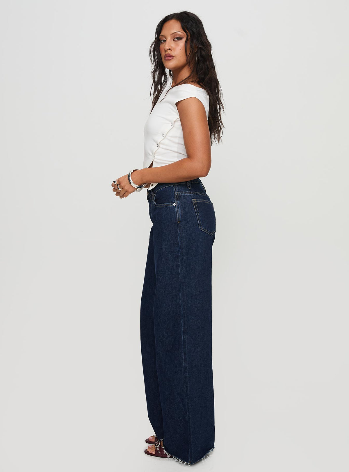 side view of model wearing Princess Polly Darla Low Rise Straight Jean Dark Wash Petite Low Rise Jeans 