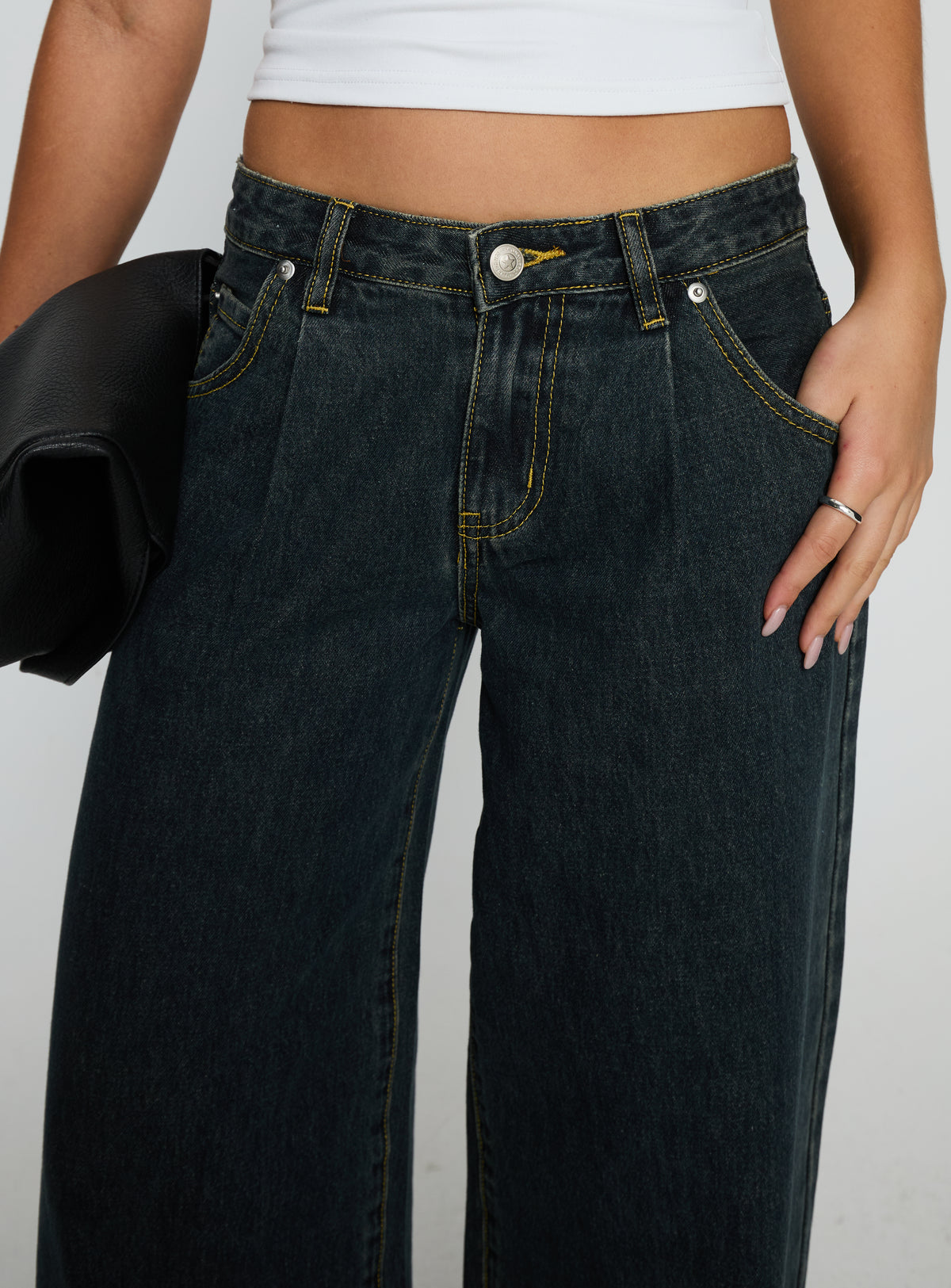 side view of model wearing Princess Polly Supercut Low Rise Baggy Pleat Jeans Grunge Wash Low Rise Jeans 