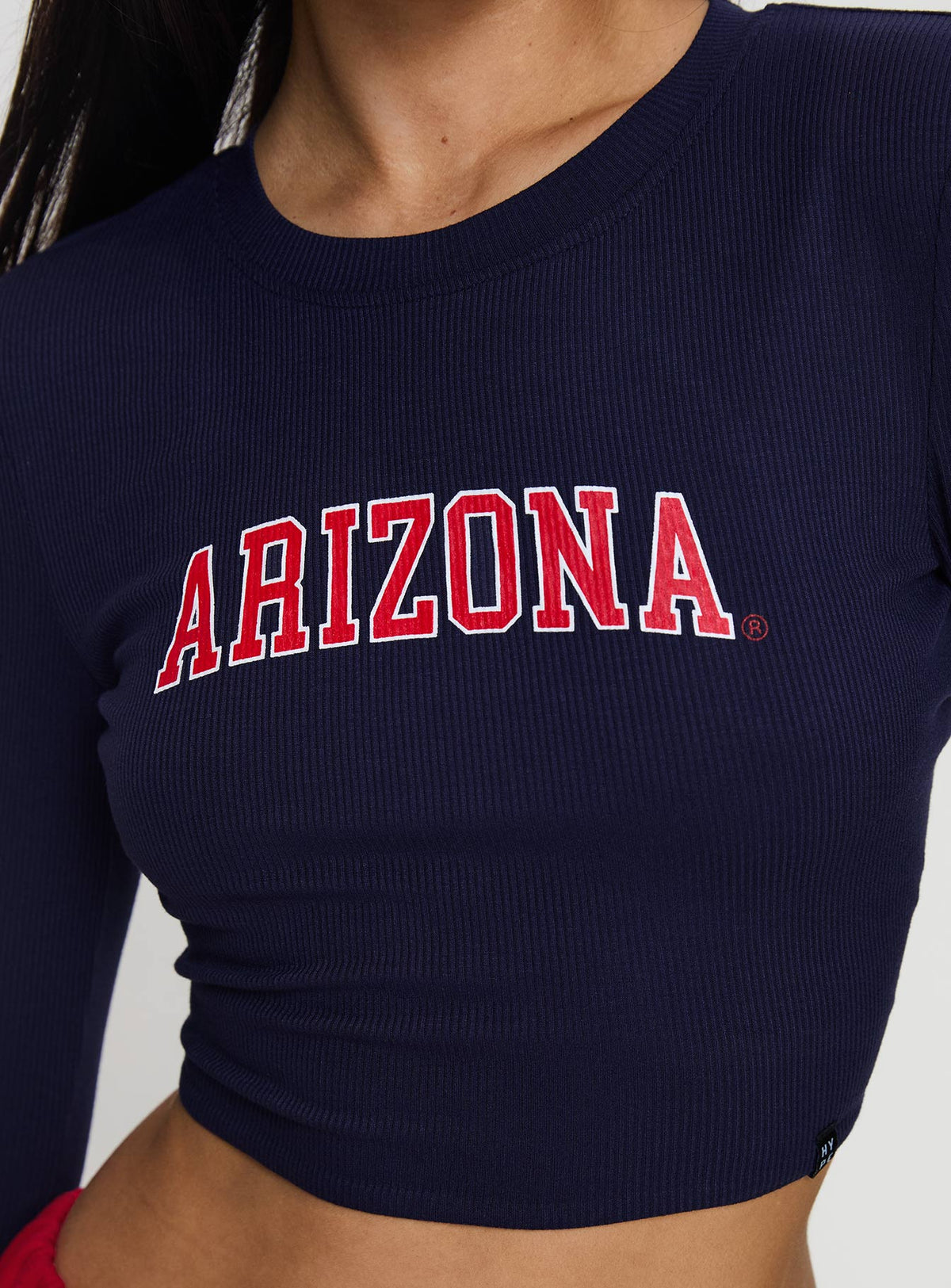 side view of model wearing Princess Polly U of A Bring It Back Long Sleeve Top Navy Full Sleeves Crew Neck 