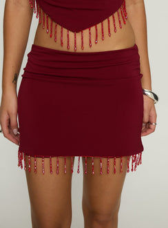 back view of model wearing Princess Polly Ginah Bead Tassel Mini Skirt Red Mini Skirts Skirts 