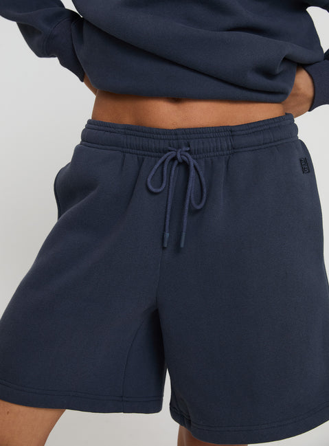 back view of model wearing Princess Polly Dream Fleece Longline Shorts Navy High Waisted Shorts 