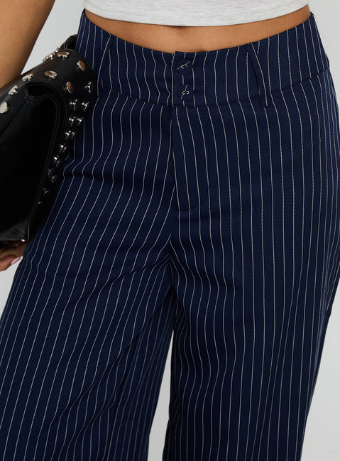 back view of model wearing Princess Polly Lorenne Mid Rise Pant Navy Pinstripe High Rise Pants Pants 