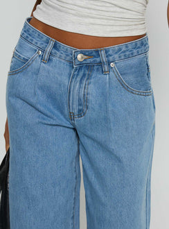 side view of model wearing Princess Polly Supercut Low Rise Baggy Pleat Jeans Light Blue Wash Low Rise Jeans Jeans 