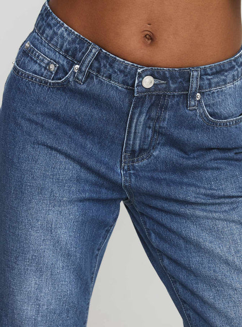 back view of model wearing Princess Polly Leslee Mid Rise Flare Jean Mid Wash Blue Mid Rise Jeans Jeans 