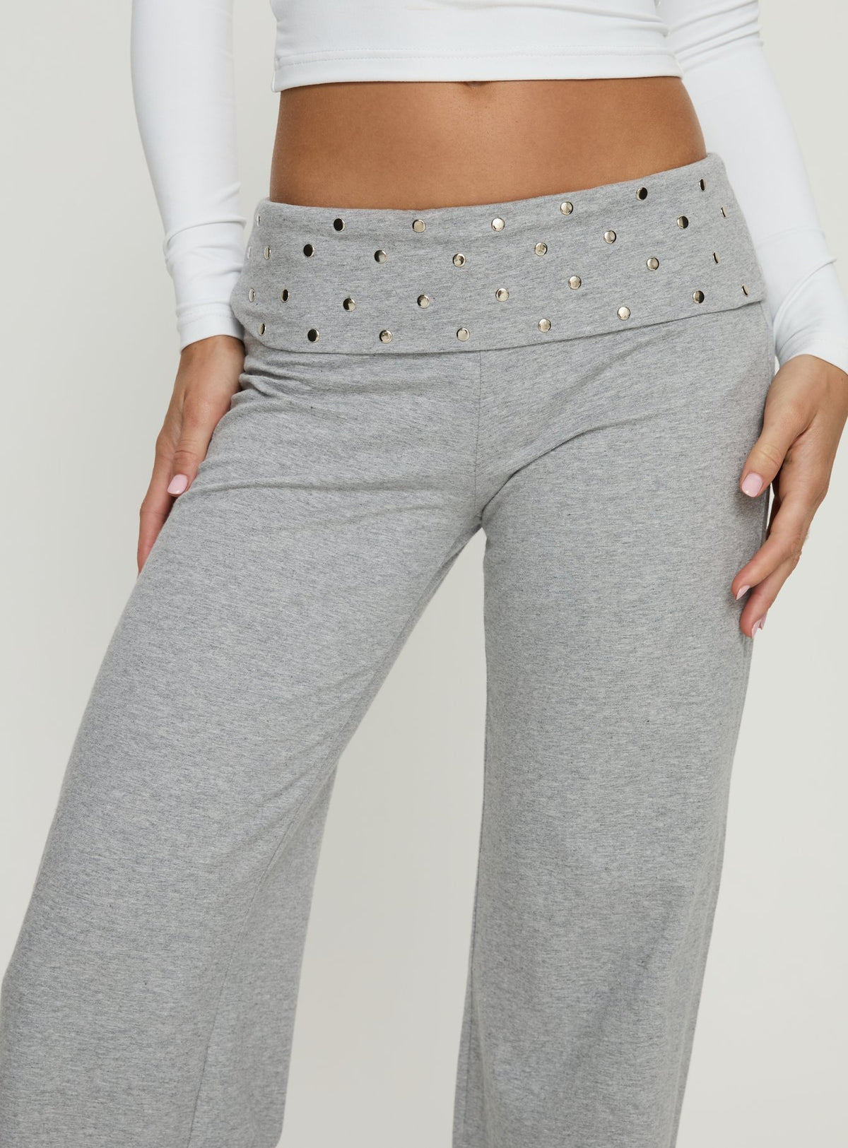 Showcasing the Nevivi Foldover Studded Pants Grey Marle womens-regular-pants with high-rise waist front view of model wearing Princess Polly