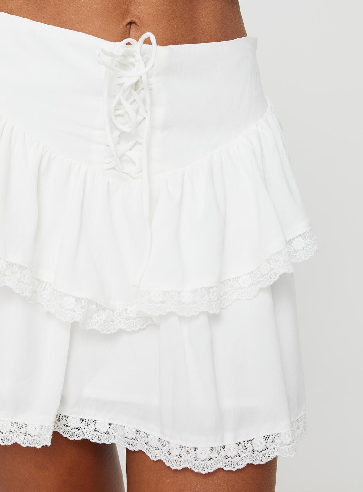 back view of model wearing Princess Polly Capshaw Mini Skirt White Mini Skirts Skirts 