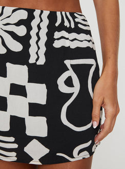 back view of model wearing Princess Polly Caraliia Mini Skirt Black / Cream Mini Skirts Skirts 