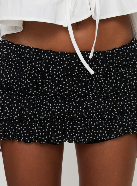 back view of model wearing Princess Polly Bebe Mini Skort Onyx Polka Low Rise Shorts 
