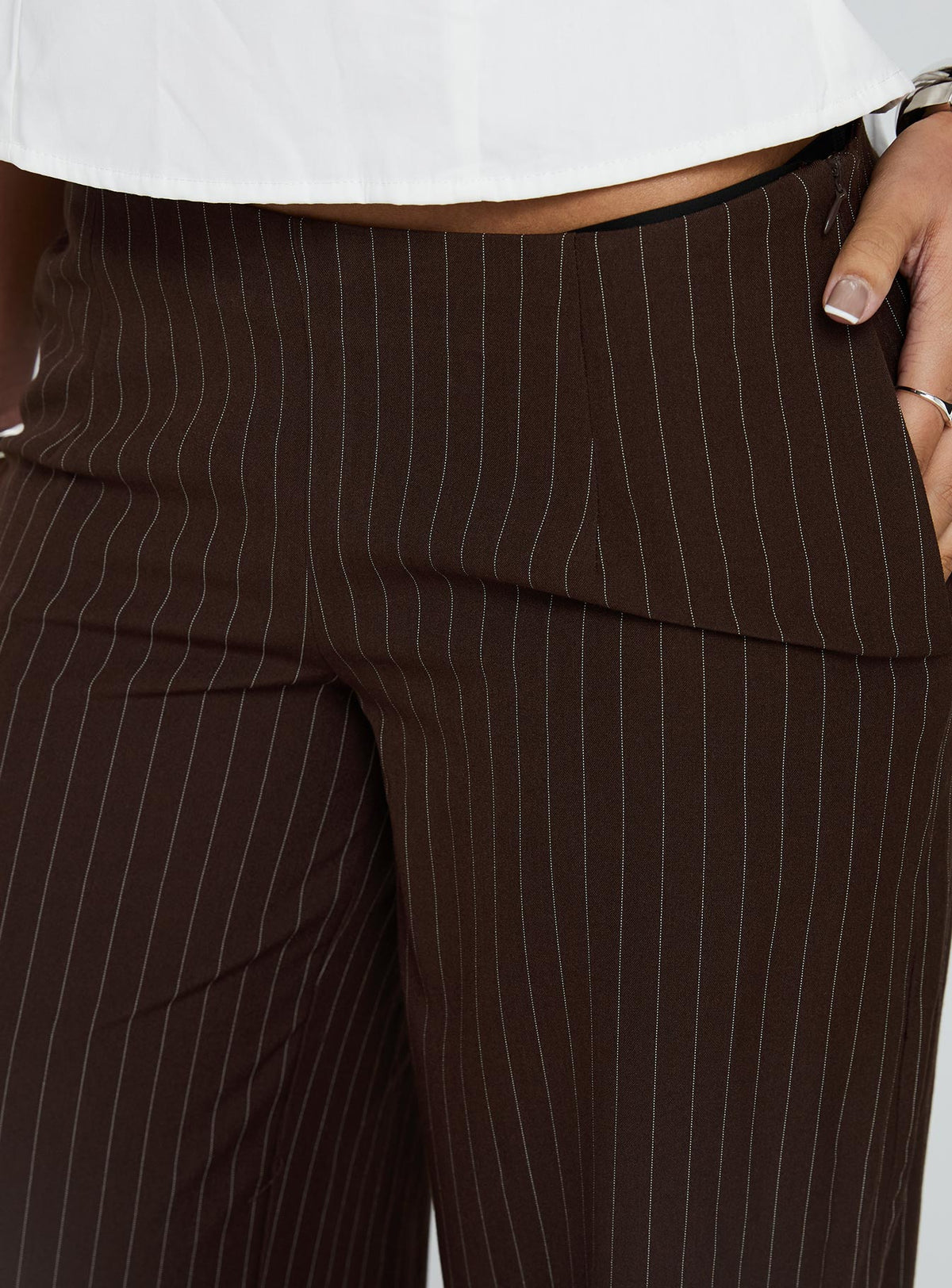 Highlighting Khane Low Rise Wide Leg Pant Brown Pinstripe Petite in womens regular pants fabric and waistline detail view of model wearing