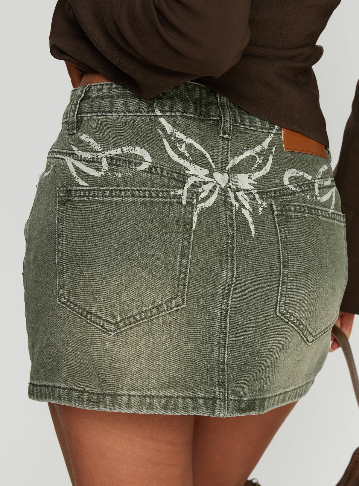   side view of model wearing Princess Polly Laynee Butterfly Mini Skirt Washed Green Mini Skirts Skirts 